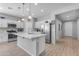 Bright kitchen with white cabinets, stainless steel appliances, a large island, and a modern faucet at 18362 W Illini St, Goodyear, AZ 85338
