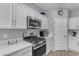 Kitchen area showcasing white cabinets, stainless steel appliances, and stylish countertops at 18362 W Illini St, Goodyear, AZ 85338