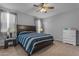 Cozy main bedroom with a ceiling fan, neutral walls, and large bed at 18362 W Illini St, Goodyear, AZ 85338