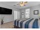 Bright main bedroom with an en suite bathroom and a large flat screen television at 18362 W Illini St, Goodyear, AZ 85338