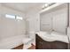 Bright bathroom features a shower-tub combo, white tile, and brown vanity at 1903 E Jasper Dr, Chandler, AZ 85225