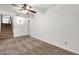This carpeted bedroom features a ceiling fan, staircase and access to the hallway at 1903 E Jasper Dr, Chandler, AZ 85225