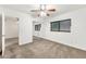 A bright bedroom with carpeted floors, large mirrored closet, and a ceiling fan at 1903 E Jasper Dr, Chandler, AZ 85225