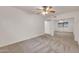 Empty bedroom with a ceiling fan, neutral carpeting and a mirrored closet at 1903 E Jasper Dr, Chandler, AZ 85225