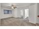Bright, carpeted bedroom featuring a ceiling fan and window, creating a comfortable and inviting space at 1903 E Jasper Dr, Chandler, AZ 85225