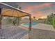 The backyard features a gazebo, pavers, a pool, and desert landscaping for a relaxing outdoor experience at 1903 E Jasper Dr, Chandler, AZ 85225