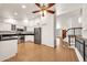 Bright kitchen with white cabinets, stainless appliances, granite countertops, and wood flooring at 1903 E Jasper Dr, Chandler, AZ 85225