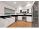 Well-lit kitchen with stainless steel appliances, granite countertops, and white cabinetry at 1903 E Jasper Dr, Chandler, AZ 85225