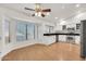 Bright kitchen with white cabinets, stainless appliances, granite countertops, wood flooring, and large windows at 1903 E Jasper Dr, Chandler, AZ 85225