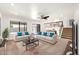 Inviting living room with stylish sofas, a ceiling fan, and access to the backyard, creating a cozy atmosphere at 1903 E Jasper Dr, Chandler, AZ 85225