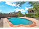 Backyard view of a sparkling blue pool with red brick trim at 1903 E Jasper Dr, Chandler, AZ 85225