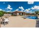 Spacious backyard featuring a sparkling pool, patio area, and lush landscaping with a large seating area at 20826 S Hadrian Way, Queen Creek, AZ 85142