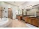 Luxurious bathroom with a soaking tub, tiled shower, and dual vanities at 20826 S Hadrian Way, Queen Creek, AZ 85142