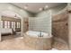 Beautiful bathroom with a soaking tub, tiled shower, and views into the main bedroom at 20826 S Hadrian Way, Queen Creek, AZ 85142