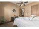 Comfortable bedroom with a fan, a white comforter and a Route 66 sign at 20826 S Hadrian Way, Queen Creek, AZ 85142