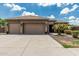 Attractive single-story home with a tile roof, three-car garage, and well-maintained landscaping at 20826 S Hadrian Way, Queen Creek, AZ 85142