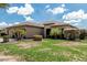 Beautiful residence showcasing well-kept landscaping, mature palm trees, and a tidy green lawn at 20826 S Hadrian Way, Queen Creek, AZ 85142