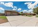 Delightful home with a spacious driveway, mature trees, and a neat, green lawn area at 20826 S Hadrian Way, Queen Creek, AZ 85142
