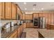 Well-equipped kitchen with stainless steel appliances, granite countertops, and wood cabinets at 20826 S Hadrian Way, Queen Creek, AZ 85142