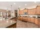 Open kitchen with a large island, granite counters, stainless appliances, and wood cabinets at 20826 S Hadrian Way, Queen Creek, AZ 85142