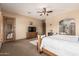 This main bedroom boasts a ceiling fan, ample natural light, ensuite bathroom, and a cozy seating area at 20826 S Hadrian Way, Queen Creek, AZ 85142
