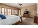This main bedroom features a ceiling fan, ample natural light, ensuite bathroom, and a cozy seating area at 20826 S Hadrian Way, Queen Creek, AZ 85142