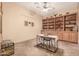Functional home office with a built-in wood bookcase, desk, and decor at 20826 S Hadrian Way, Queen Creek, AZ 85142