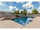 Expansive pool with rock features and plenty of space for entertaining at 20826 S Hadrian Way, Queen Creek, AZ 85142