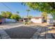 Spacious backyard with gravel, stone pavers, palm trees, and potential for outdoor entertaining at 2214 N 7Th Ave, Phoenix, AZ 85007