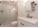 Stylish bathroom features a modern vanity and a luxurious walk-in shower with marble-style tile at 2214 N 7Th Ave, Phoenix, AZ 85007