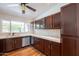 Well-lit kitchen boasts dark wood cabinets, stainless steel appliances, and a mosaic backsplash above the countertops at 2214 N 7Th Ave, Phoenix, AZ 85007