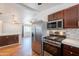 Open-concept kitchen with stainless steel appliances and a bar area overlooking the adjacent living space at 2214 N 7Th Ave, Phoenix, AZ 85007