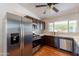 Modern kitchen featuring stainless steel appliances, dark wood cabinets, tile backsplash, and wood-look floors at 2214 N 7Th Ave, Phoenix, AZ 85007