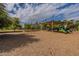 Outdoor playground offers slides, swings, and climbing structures on a mulch ground, framed by trees at 2214 N 7Th Ave, Phoenix, AZ 85007