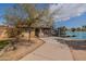 Pool area with a gate leading to the pool and lake, partially obscured by a tree at 2214 N 7Th Ave, Phoenix, AZ 85007