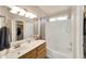 Bathroom featuring a tub and shower combination with a large mirror and lighting at 2221 E Union Hills Dr # 148, Phoenix, AZ 85024
