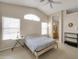 Bright bedroom features a ceiling fan, arch window, and an attached bathroom at 2221 E Union Hills Dr # 148, Phoenix, AZ 85024