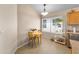 Bright dining nook features a window with plants, a table for two, and tile flooring at 2221 E Union Hills Dr # 148, Phoenix, AZ 85024