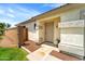 A close up of the front door and porch features desert landscaping and a neutral color palette at 2221 E Union Hills Dr # 148, Phoenix, AZ 85024