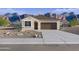A beautifully landscaped single-story home with a desert-style front yard and a spacious driveway at 22720 N Lynn St, Maricopa, AZ 85138