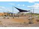 Community playground featuring ample seating, sun shades, desert landscape, and well-maintained walking trails at 22720 N Lynn St, Maricopa, AZ 85138
