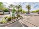 Community entrance with meticulously maintained landscaping, mature palm trees, and brick-paved street at 2402 E 5Th St # 1520, Tempe, AZ 85288