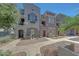 Three-story townhomes featuring private entrances, desert landscaping, and neutral stucco at 2402 E 5Th St # 1520, Tempe, AZ 85288