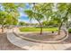 Outdoor common area with a grassy field, mature trees, and inviting walking paths at 2402 E 5Th St # 1520, Tempe, AZ 85288