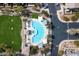 Aerial view of resort-style pool with ample seating, umbrellas, and lush green landscaping at 2402 E 5Th St # 1520, Tempe, AZ 85288