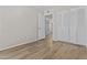 Bedroom featuring a closet, hardwood flooring, and a view into the hallway at 2435 E Harmony Ave, Mesa, AZ 85204