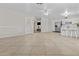 Large open floor plan offers a view of the kitchen, dining area, and entry door at 2435 E Harmony Ave, Mesa, AZ 85204