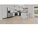 Eat-in kitchen featuring stainless steel appliances, white cabinets, and a breakfast bar for casual dining at 2435 E Harmony Ave, Mesa, AZ 85204