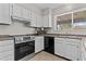 Modern kitchen featuring stainless steel range, tile backsplash, and ample white cabinetry at 2435 E Harmony Ave, Mesa, AZ 85204