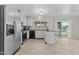 Bright kitchen features stainless steel appliances, a breakfast bar, and access to the backyard at 2435 E Harmony Ave, Mesa, AZ 85204